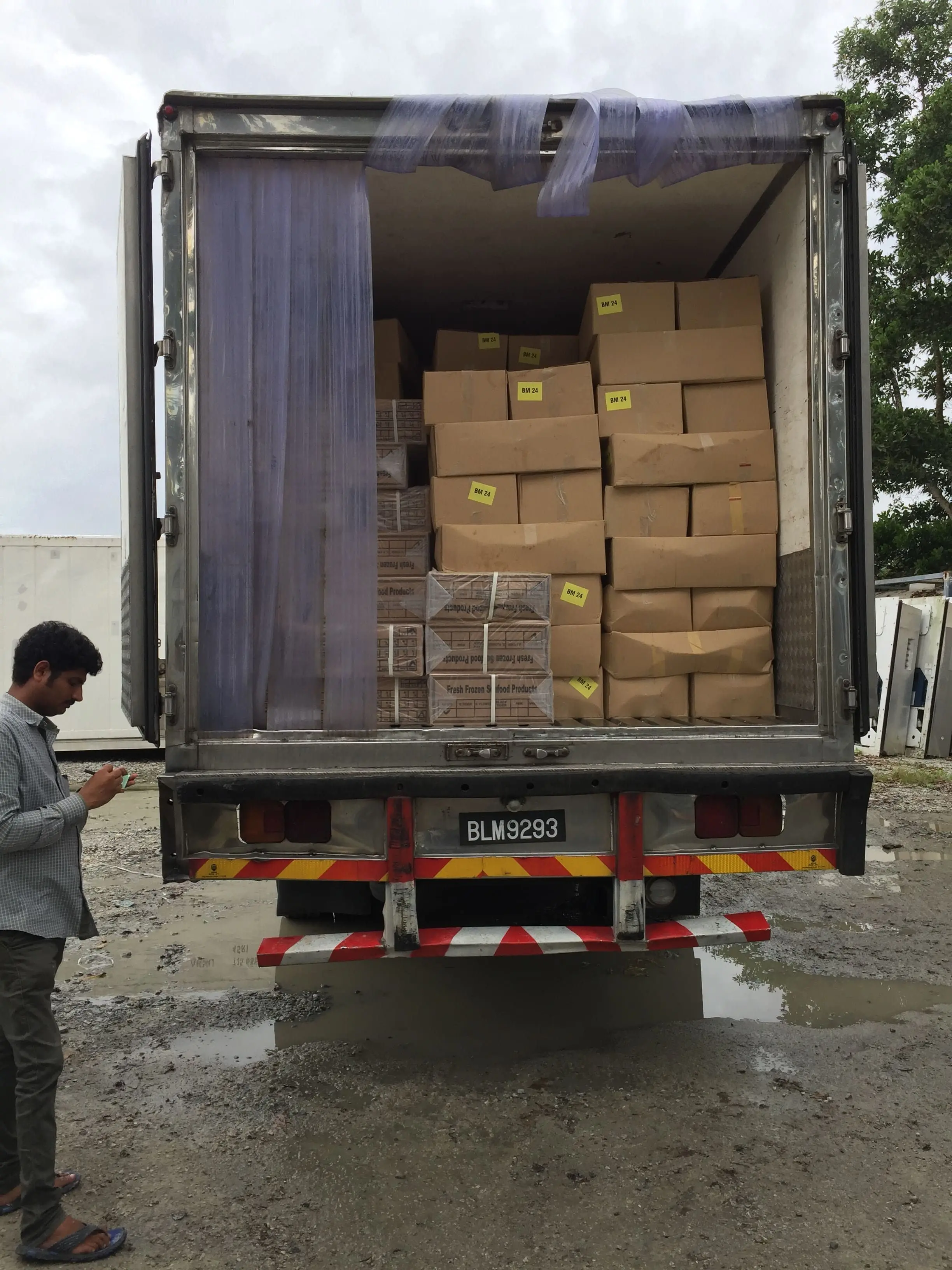 Rear view of a Mileford lorry interior filled with various organized cardboard boxes for safe transit.